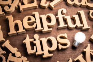 wooden letters on table that spell "helpful tips"