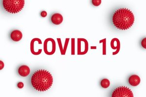The words COVID-19 surrounded by virus-like particles.