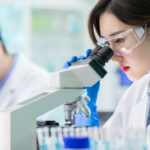 close up of asian female scientist use microscope in the laboratory