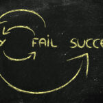 Blackboard showing the words "try", "fail" and "success", linked by arrows